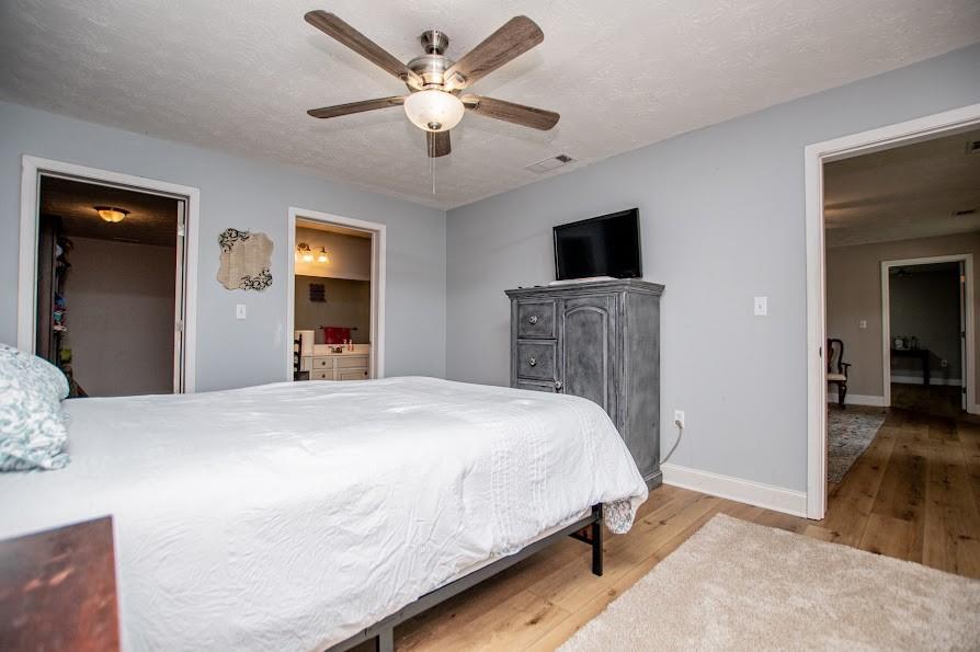 575 Liberty Church Road Carrollton, GA 30116 - Photo 52 of 95 a bedroom with a bed and a flat tv screen on dresser
