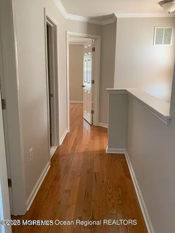 a view of hallway with wooden floor