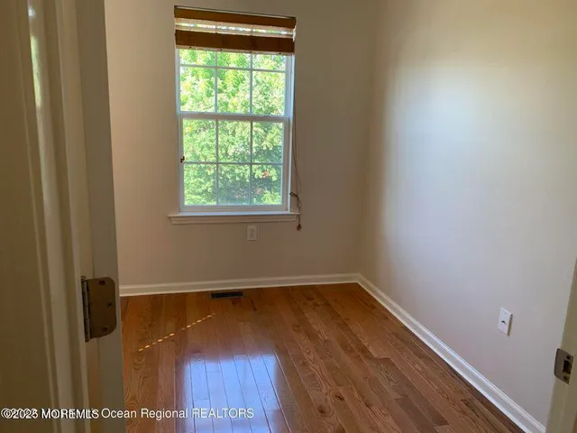 a view of a room with wooden floor and window