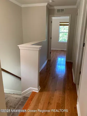 a view of hallway with wooden floor