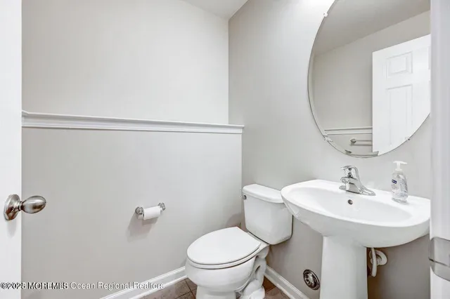 a bathroom with a sink toilet and a mirror