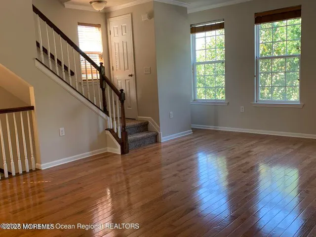 a view of entryway and hall with wooden floor