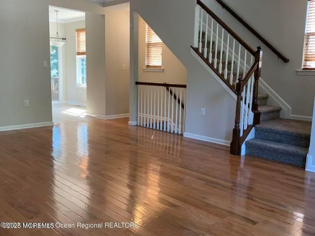 a view of an entryway with wooden floor