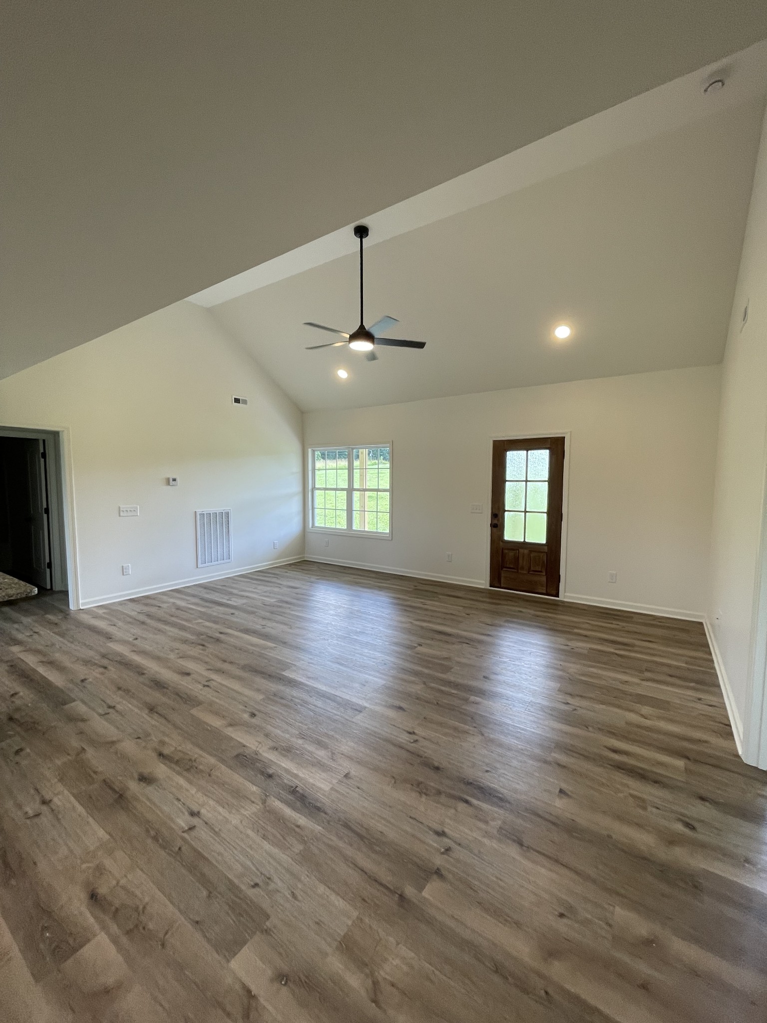 2907 Union Camp Road Lafayette, TN 37083 - Photo 11 of 24 an empty room with wooden floor and windows