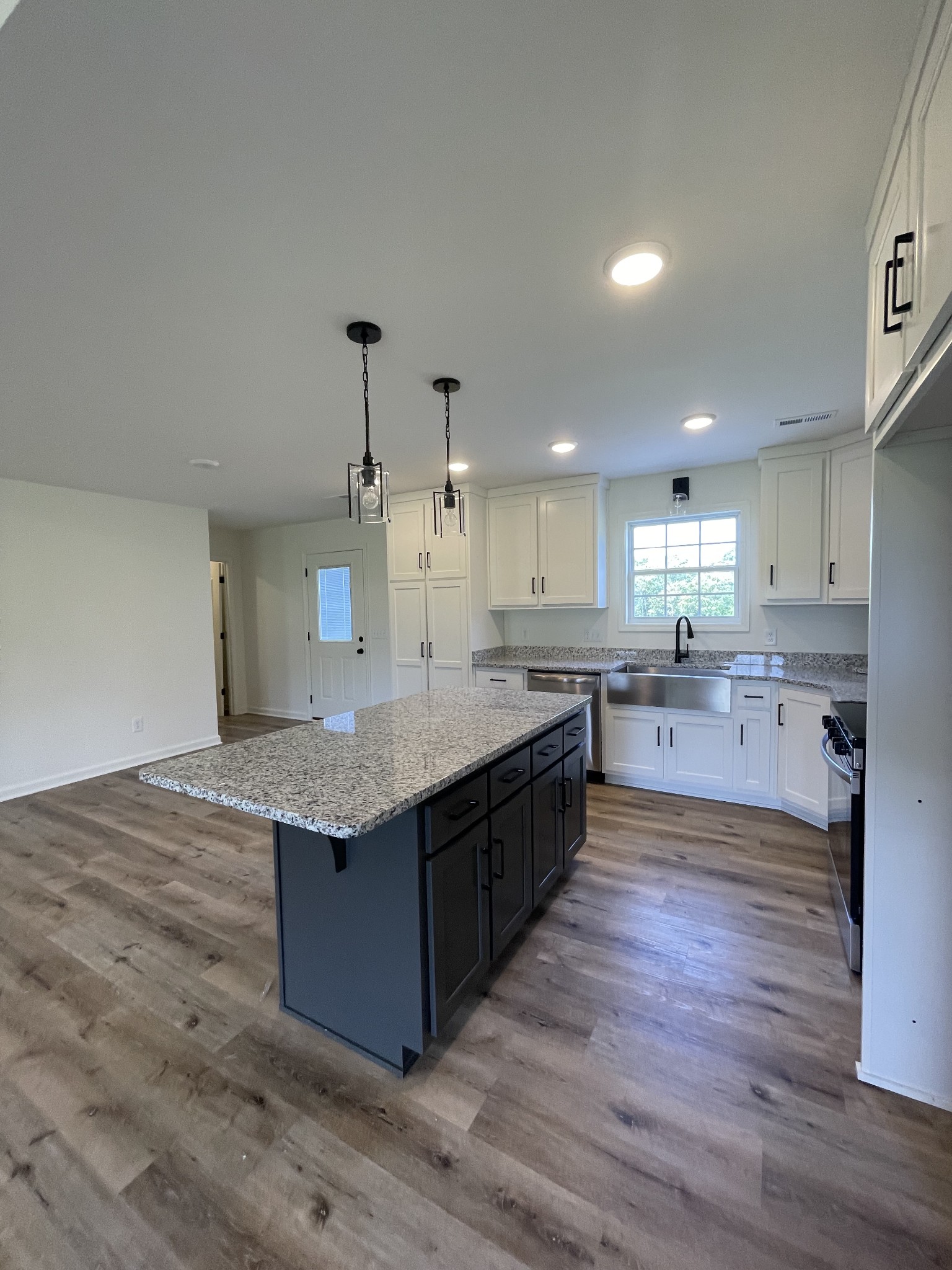 2907 Union Camp Road Lafayette, TN 37083 - Photo 15 of 24 a large kitchen with a center island and stainless steel appliances