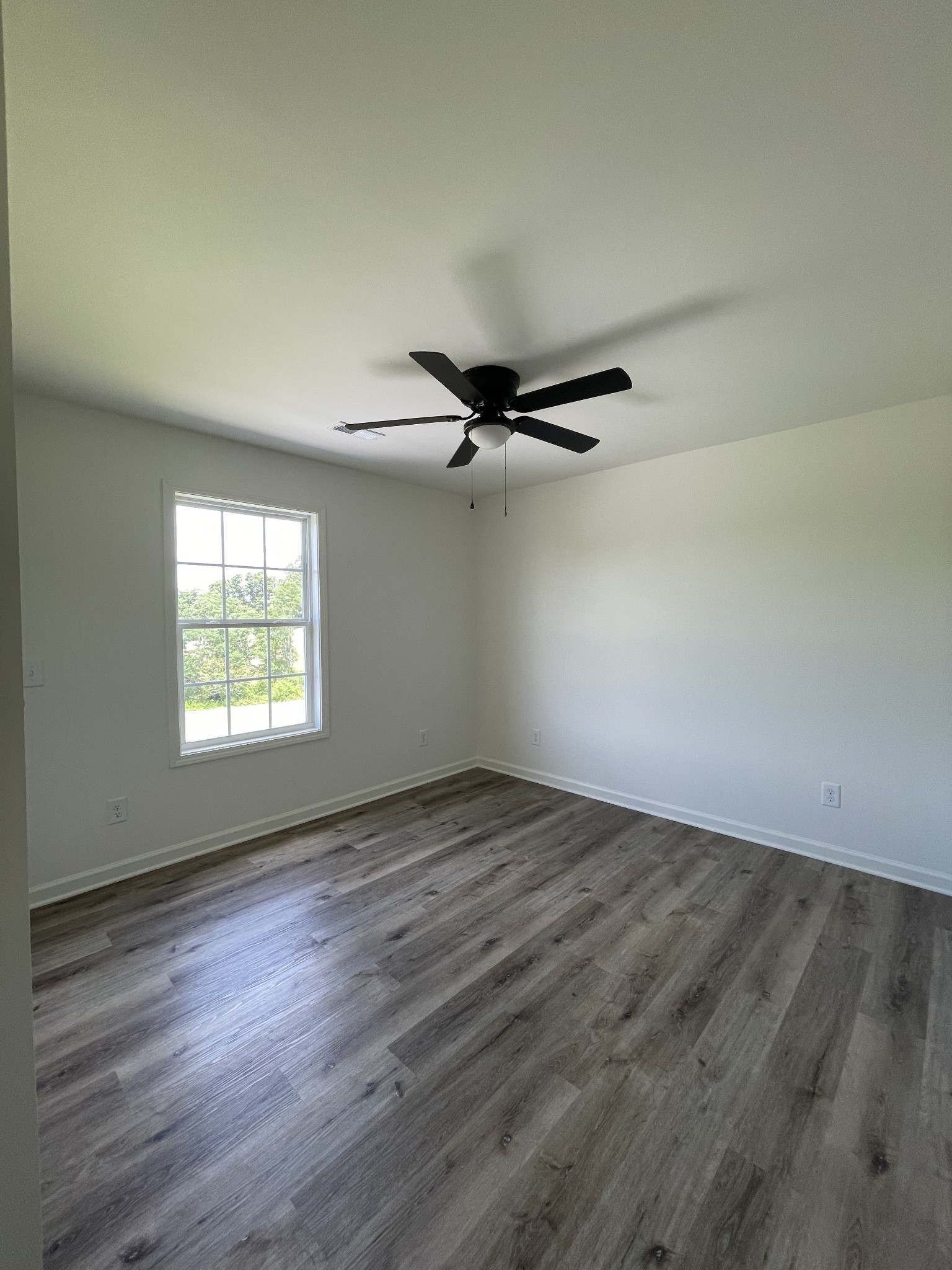 2907 Union Camp Road Lafayette, TN 37083 - Photo 19 of 24 an empty room with wooden floor fan and windows