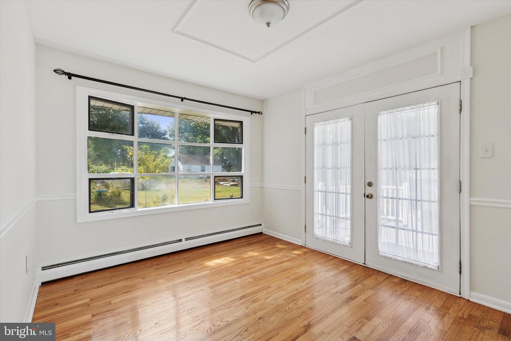 756 Churchville Road Southampton, PA 18966 - Photo 5 of 19 an empty room with wooden floor and windows