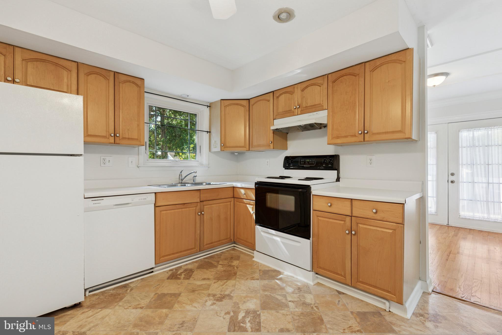 756 Churchville Road Southampton, PA 18966 - Photo 7 of 19 a kitchen with granite countertop a refrigerator sink stove and microwave