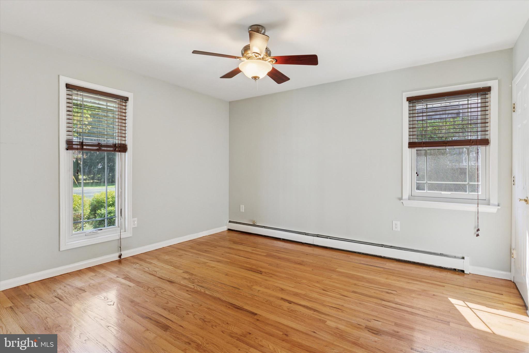 756 Churchville Road Southampton, PA 18966 - Photo 8 of 19 a view of empty room with wooden floor and fan