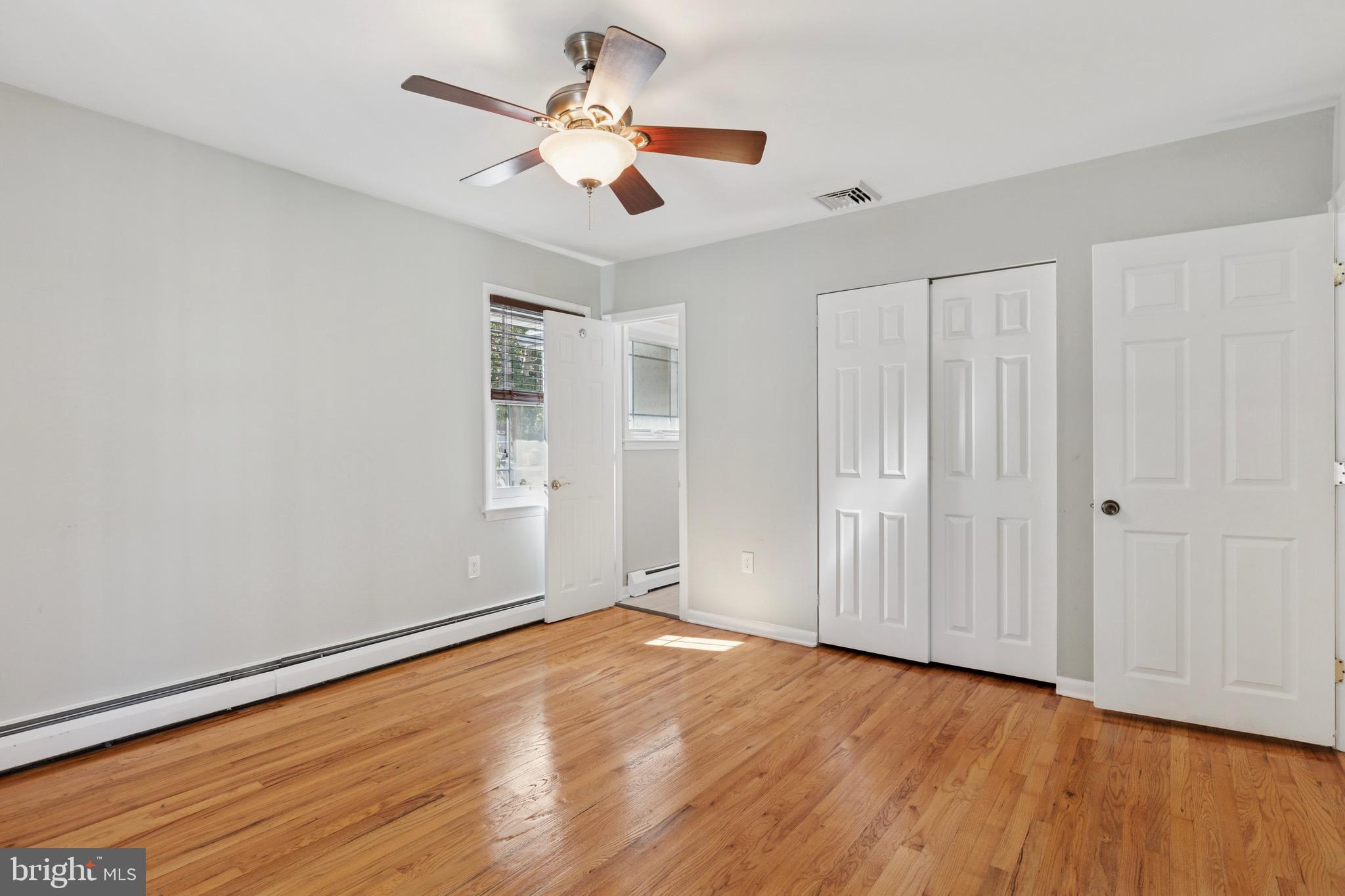 756 Churchville Road Southampton, PA 18966 - Photo 9 of 19 an empty room with wooden floor chandelier fan and windows