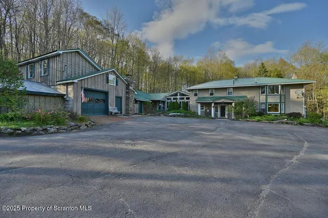 a front view of a house with a yard and a garage