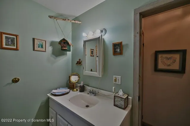 a bedroom with a large bed a chandelier and dresser