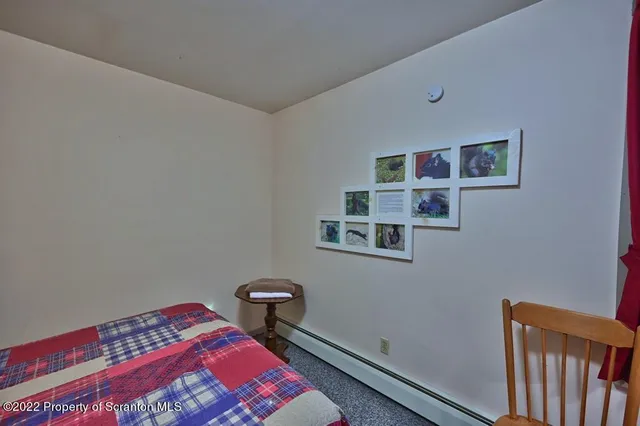 a bathroom with a granite countertop toilet sink and mirror