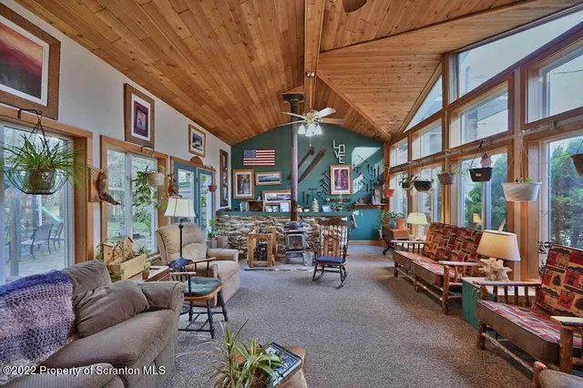 a view of a house with a yard and sitting area