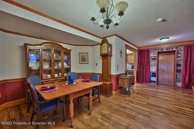 a view of backyard with table and chairs and potted plants