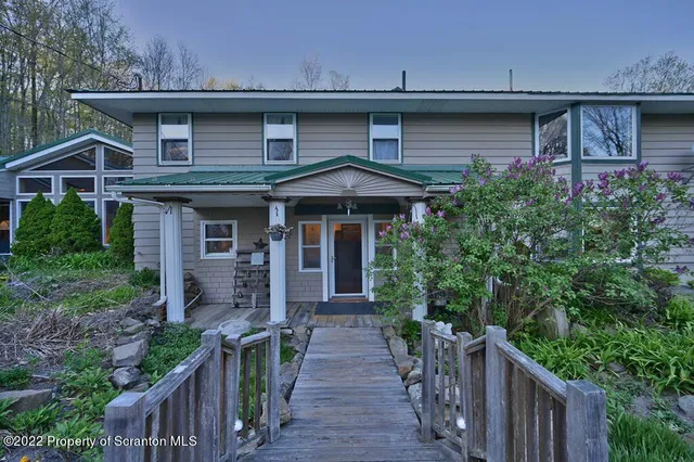 a bathroom with a sink a toilet and shower curtain