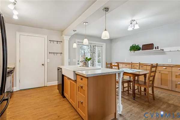 a kitchen with kitchen island a sink counter and chairs