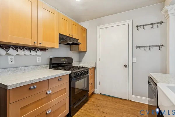 a kitchen with stainless steel appliances granite countertop a stove and a refrigerator