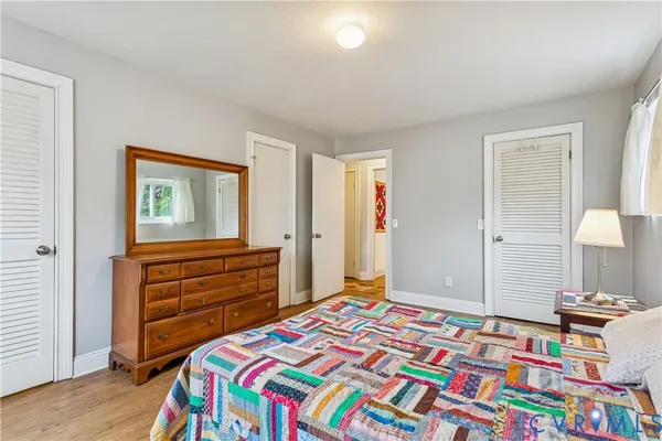 a bedroom with a bed and a dresser in it