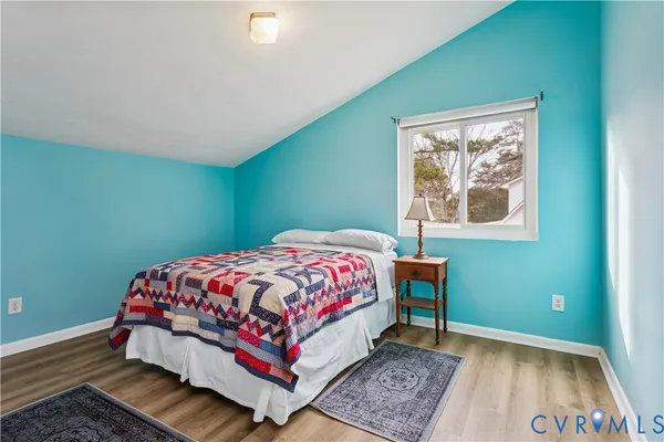 a bedroom with a bed lamp and a window