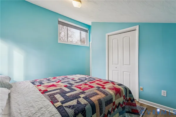 a bedroom with a bed and a window