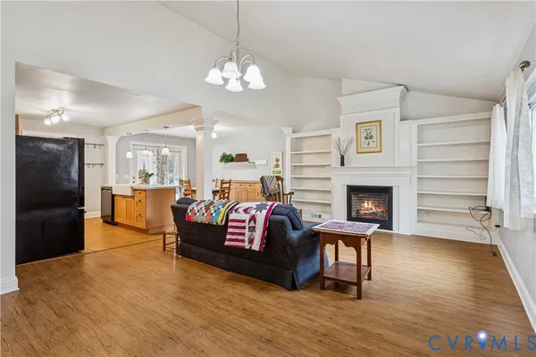 a living room with furniture fireplace and a table