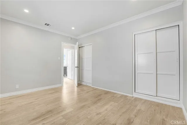 a view of a room with wooden floor and windows