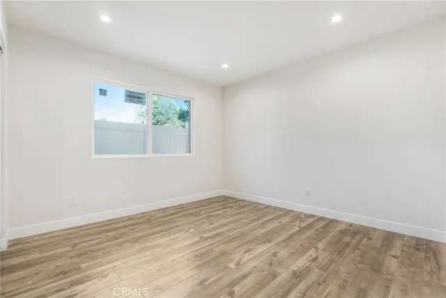 a bathroom with a toilet sink vanity and mirror