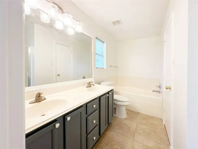 a bathroom with a bathtub and shower