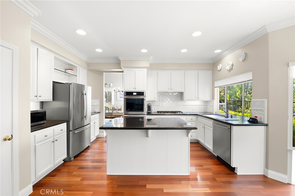 28561 Camelback Road Trabuco Canyon, CA 92679 - Photo 22 of 66 a large kitchen with stainless steel appliances and a sink