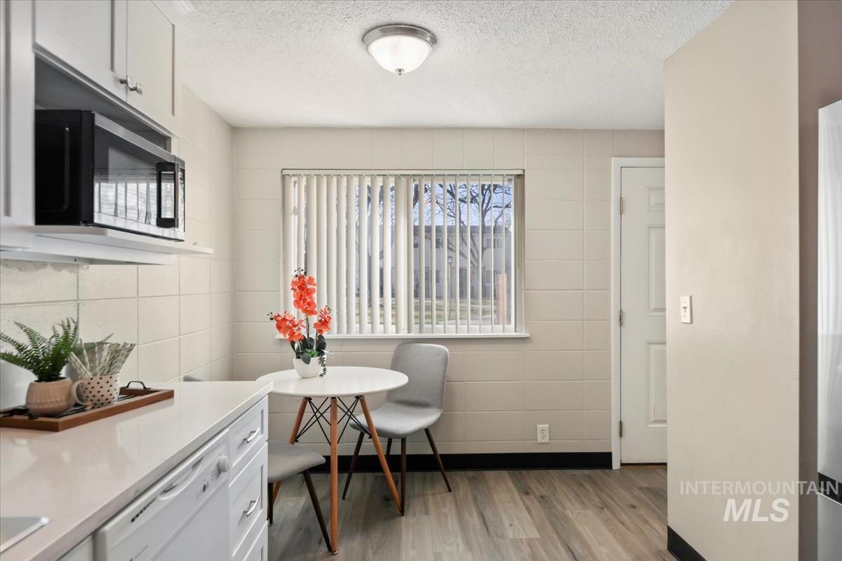 952 South Curtis Road Boise, ID 83705 - Photo 21 of 37 Dining room featuring light wood-style flooring and a textured ceiling