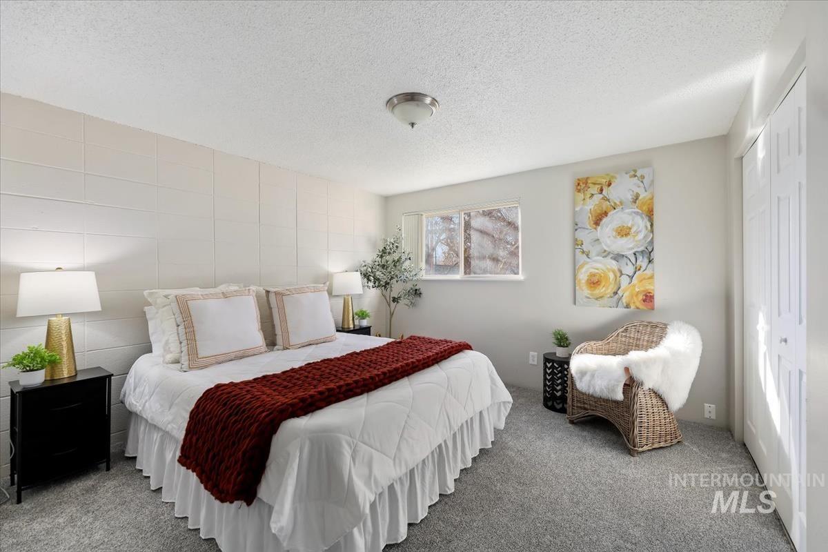 952 South Curtis Road Boise, ID 83705 - Photo 25 of 37 Carpeted bedroom with a textured ceiling and a closet