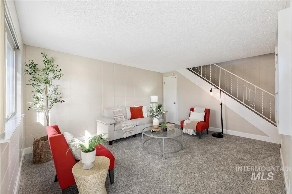 952 South Curtis Road Boise, ID 83705 - Photo 5 of 37 Carpeted living room featuring stairway and a textured ceiling