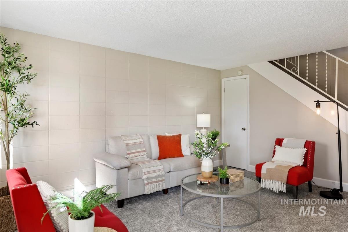 952 South Curtis Road Boise, ID 83705 - Photo 6 of 37 Living room with tile walls, stairway, and a textured ceiling