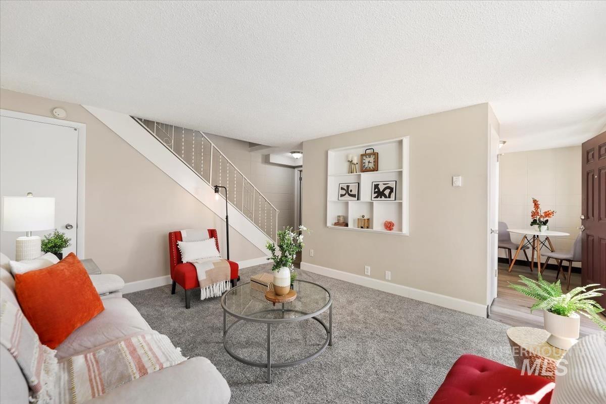 952 South Curtis Road Boise, ID 83705 - Photo 7 of 37 Living area with a textured ceiling, stairs, and carpet floors