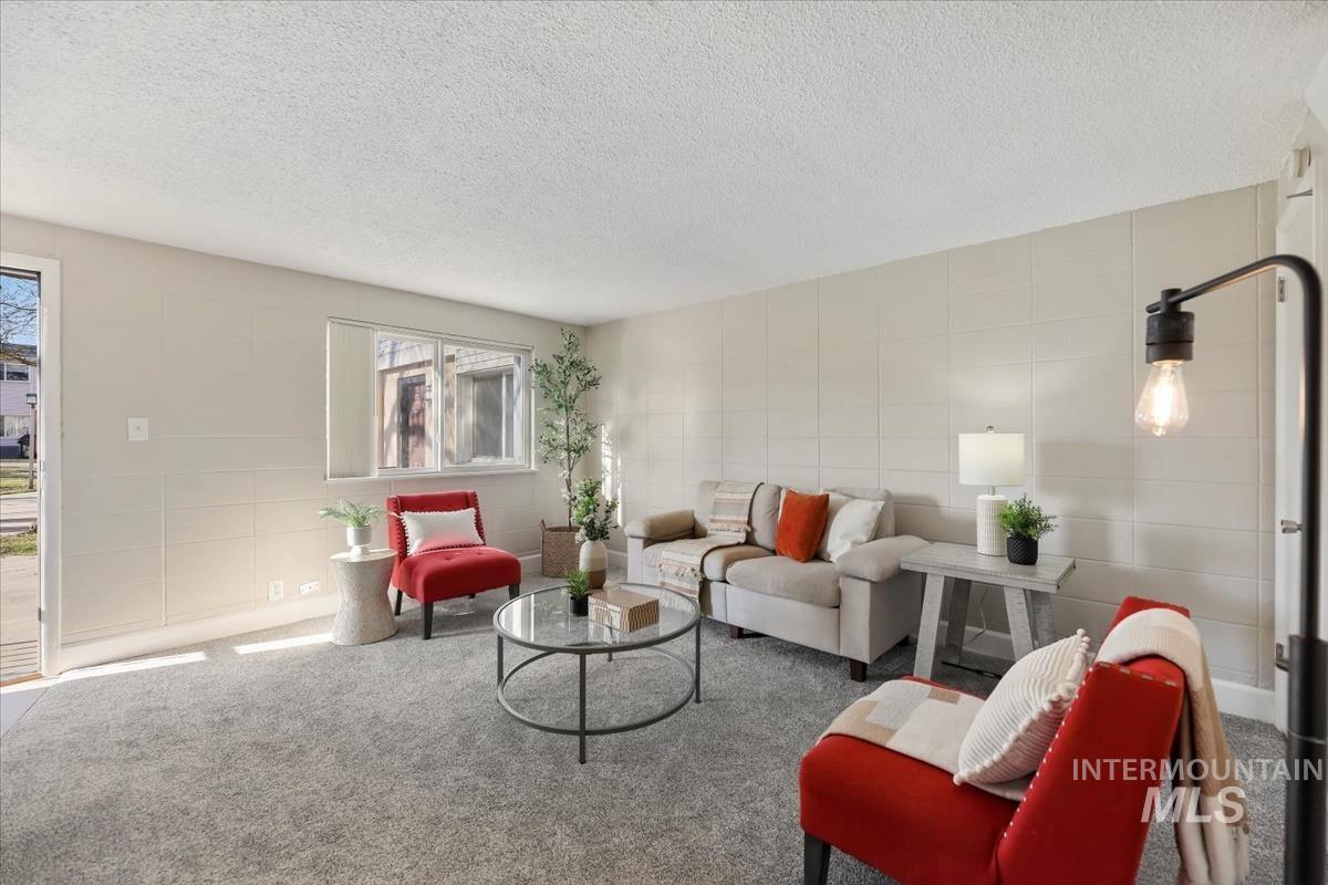 952 South Curtis Road Boise, ID 83705 - Photo 9 of 37 Living area featuring a textured ceiling and carpet floors