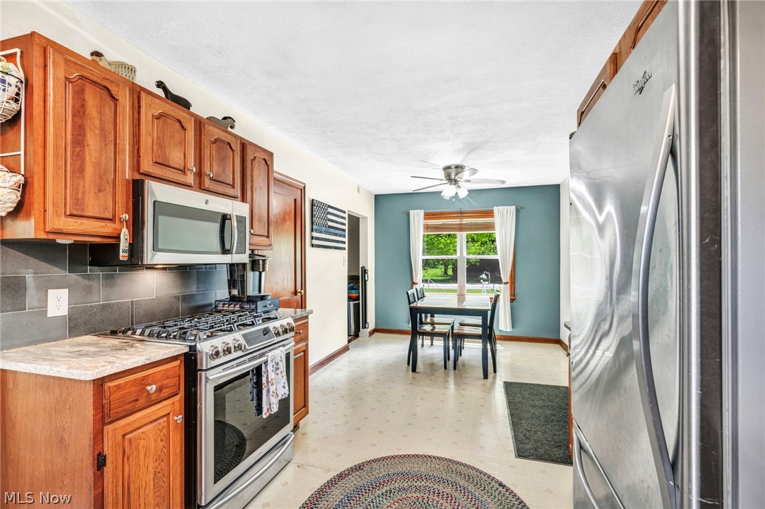 7983 Wadsworth Road Medina, OH 44256 - Photo 11 of 42 Kitchen featuring tasteful backsplash, appliances with stainless steel finishes, and ceiling fan