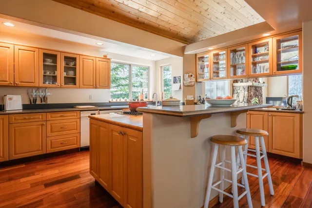 a kitchen with granite countertop a sink stove and cabinets