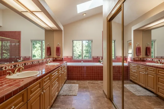 a large bathroom with a large tub and sink