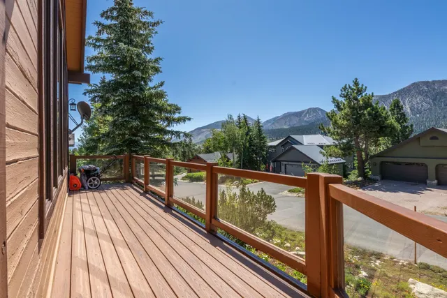 a view of balcony with wooden floor and iron fence
