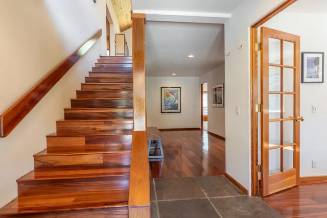 a view of an entryway with wooden floor and stairs