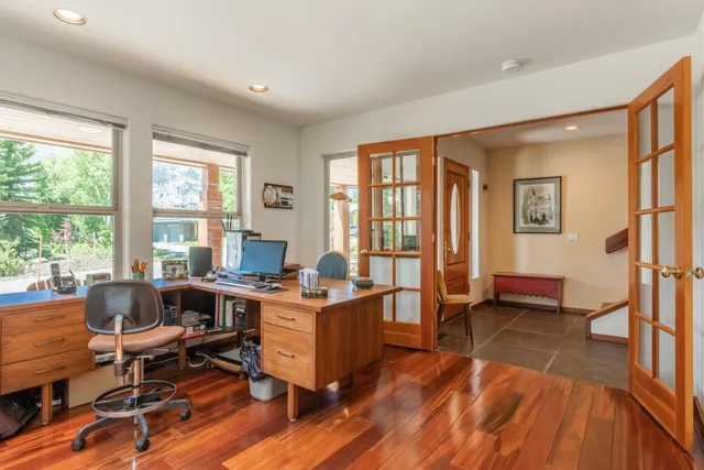 a workspace with wooden floor and a window