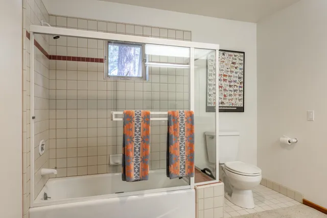 a bathroom with a toilet and a shower