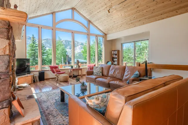 a living room with furniture city view and large windows