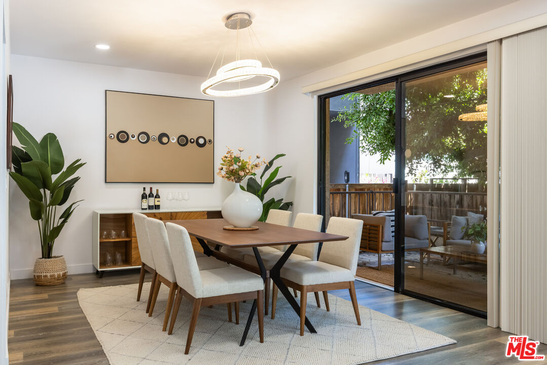 1210 North Kings Road, Unit 101 West Hollywood, CA 90069 - Photo 11 of 32 a dining room with furniture and wooden floor
