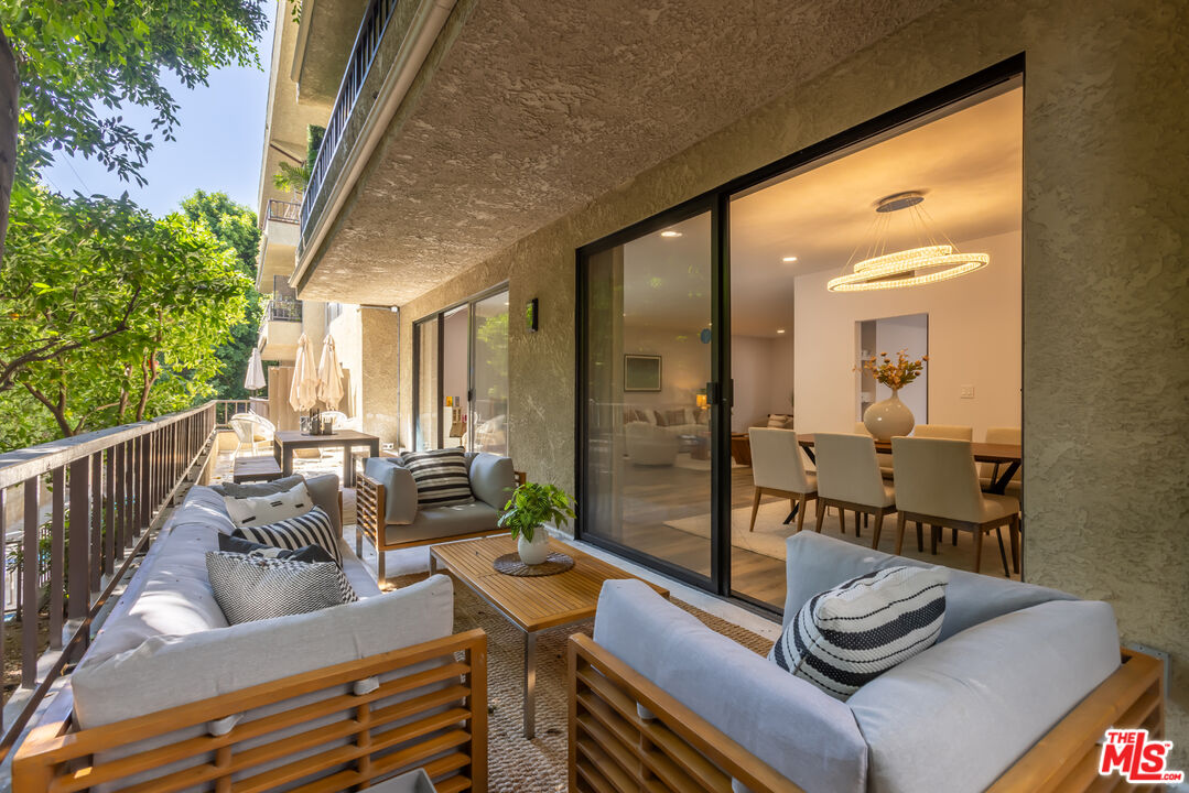 1210 North Kings Road, Unit 101 West Hollywood, CA 90069 - Photo 9 of 32 a living room with furniture and a large window