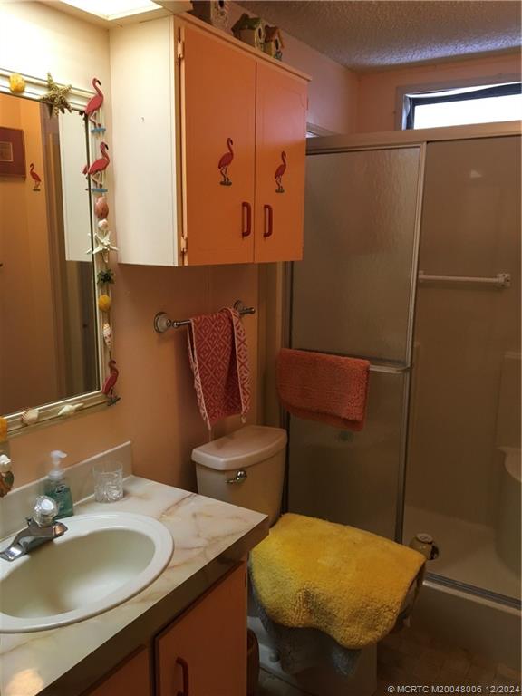 16222 Southwest Five Wood Way Indiantown, FL 34956 - Photo 11 of 13 a bathroom with a sink toilet and mirror