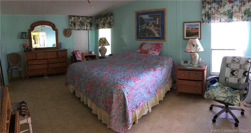 16222 Southwest Five Wood Way Indiantown, FL 34956 - Photo 12 of 13 a bedroom with bed and window