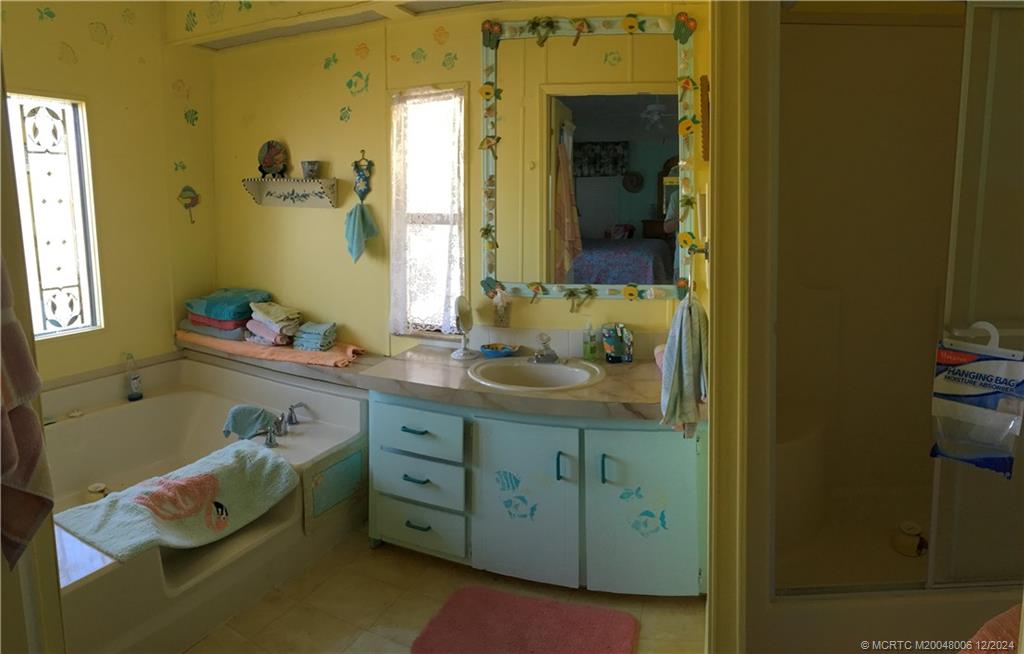 16222 Southwest Five Wood Way Indiantown, FL 34956 - Photo 13 of 13 a bathroom with a granite countertop sink and a mirror