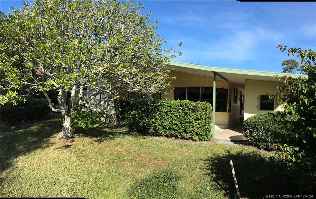 16222 Southwest Five Wood Way Indiantown, FL 34956 - Photo 2 of 13 a front view of a house with garden